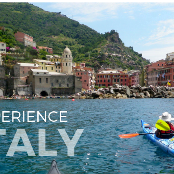 Women on kayaks tour the Italian city of Cinque Terre on the Italy Kayaking Adventure with Wild Women Expeditions