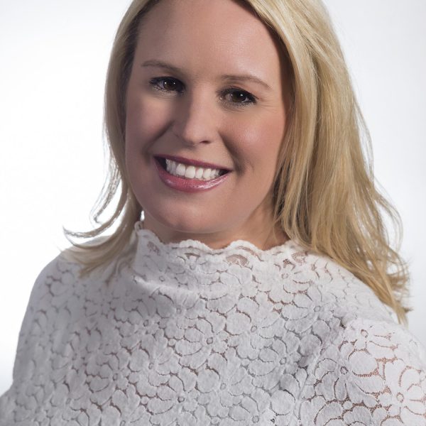 A headshot of Collette Travel CEO and President Jaclyn Leibl-Cote wearing a lace blouse.
