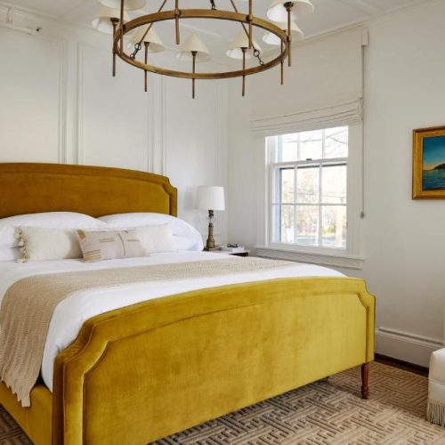 A luxurious double bed suite at Kennebunkport Captains Collection, a Lark Hotel in Kennebunkport, Maine, a safe place for women to stay.