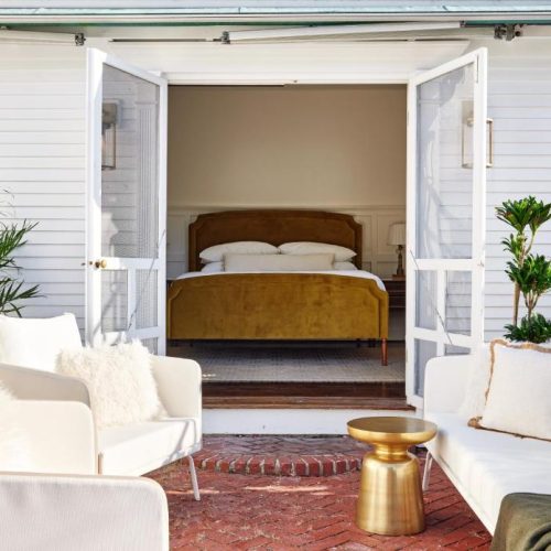 A double bed suite with walkout to patio at the Kennebunkport Captains Collection, a Lark Hotel, in Kennebunkport Maine, a safe place for women to stay.