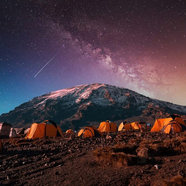 Campsite on Kilimanjaro mountain background under the Milky Way