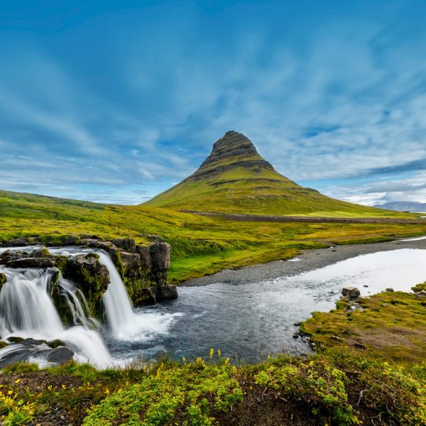 A stunning view of Kirkjufell mountain and the lush green landscape - Iceland's Westfjords & North Coast