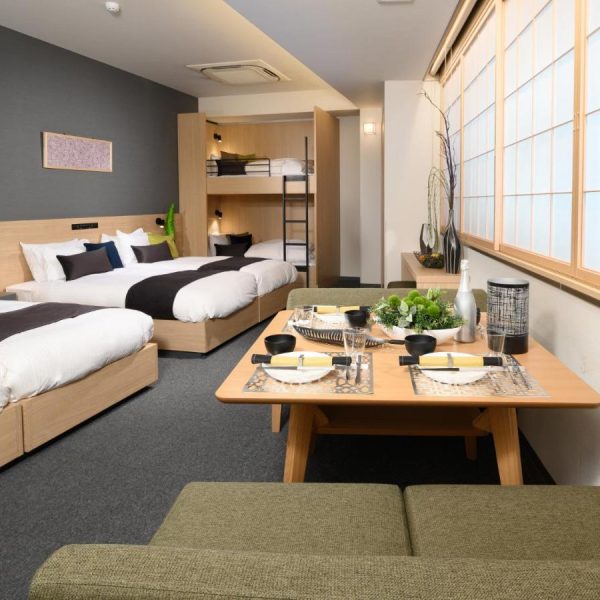 A family-sized apartment with two full beds, bunk beds and a table for four at the Mimaru Tokyo Ueno North, Japan