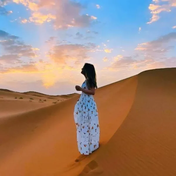 A woman overlooking the Sahara Desert - Morocco Delivered -Asgunfa Travel Morocco