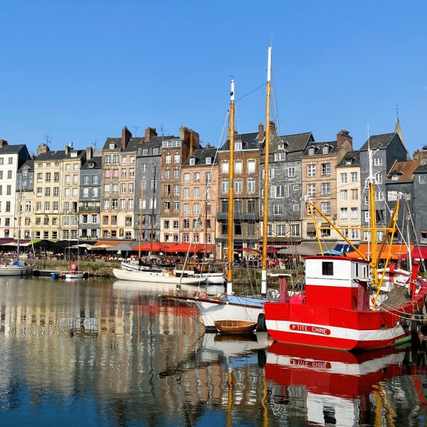 View of the picturesque port town of Honfleur in Normandy, featuring its historic waterfront buildings.