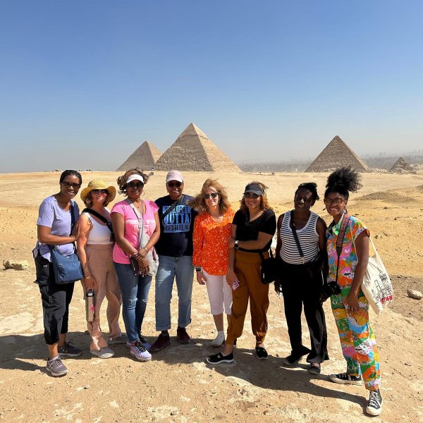 Tour participant posing for a photo with the iconic Giza Pyramid in the background - Ancient Wonders of Egypt