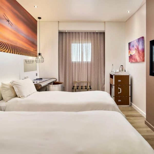 Two twin beds in a small but comfortable room at the Protea Hotel by Marriott at the airport in Johannesburg, recommended as a safe place for women to stay by a JourneyWoman reader.