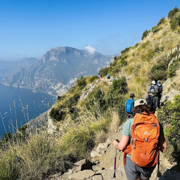 Women walk in line along a coastal path overlooking the sea - Sicily and the Amalfi Coast - Adventures in Good Company