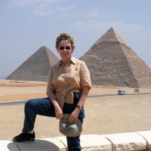 Ena Garay (aka Talek Nantes) poses for a photo with the Egyptian Pyramids behind her - Travels with Talek