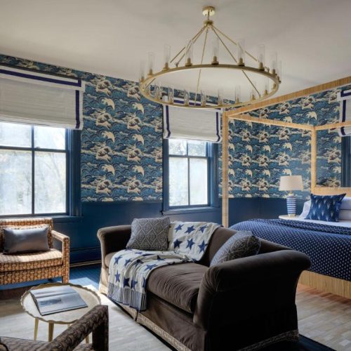 A nautical-themed bedroom suite with king bed at The Hotel Portsmouth by Lark Hotels, a safe place for women to stay in New Hampshire.