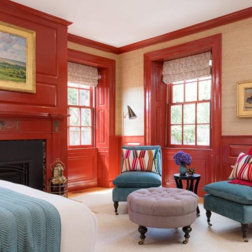 A bright orange and blue bedroom suite at The Merchant Salem by Lark Hotels, a safe place for women to stay in Salem, Massachusetts.