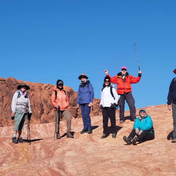 Group of hikers standing on a trail, admiring the canyon - Valley of Fire, Red Rock & Death Valley NP, Canyon Calling