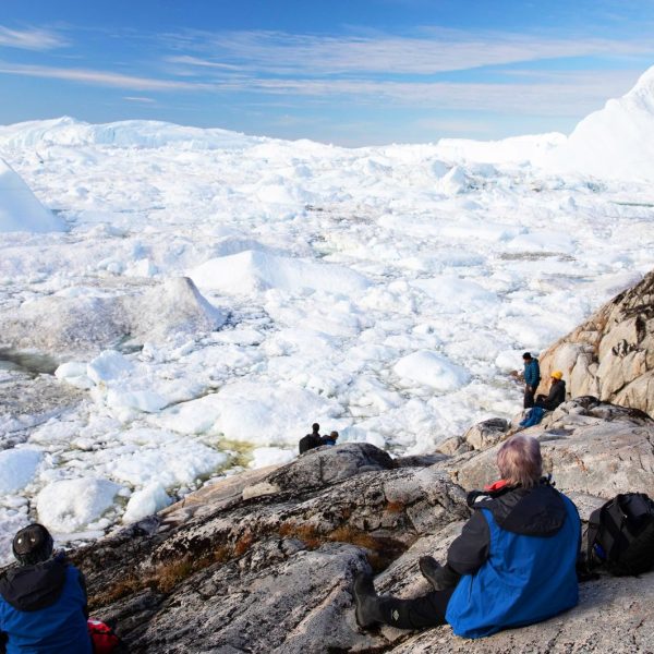 Resting at the top of a viewpoint in Ilulissat, Greenland, with stunning views of the icy landscape -