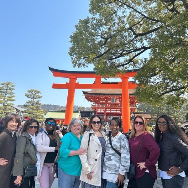 A joyful group of women exploring Japan, surrounded by vibrant cultural landmarks - Cherry Blossoms & Cultural Treasures