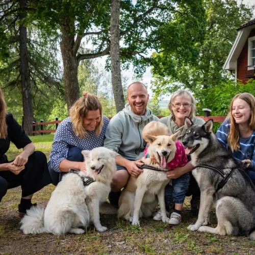 A group of smiling people—old and young—pose with their dogs. Hosts for Worldpackers, a volunteering abroad organization.