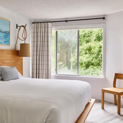 Interior of a room with double bed and serene view at the Bluebird Parker Beach Lodge in South Yarmouth, Massachusetts