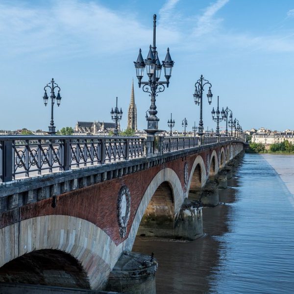 A view of the length of a bridge in Bordeaux, France to illustrate Global Palate Adventures' culinary trip in the region.