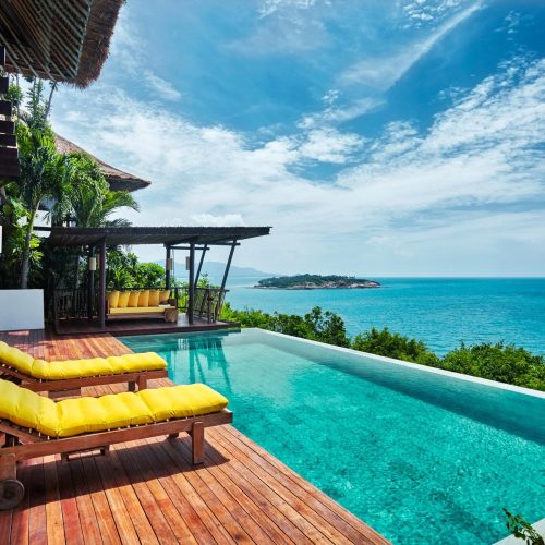 A view from the patio with sun-lit pool at the Six Senses IHG resort in Thailand.