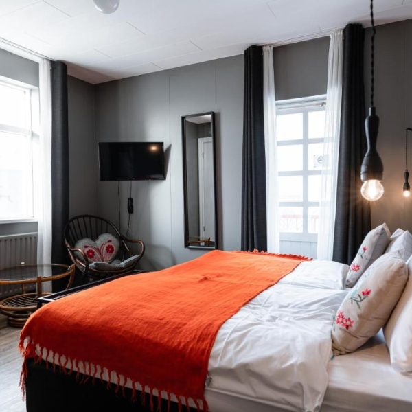 A modern, comfortable looking hotel room with a double bed and simple amenities - Hotel Leifur Eiriksson, Reykjavik Iceland