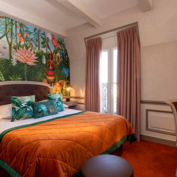 A classic double room at the Hotel and Spa St Jacques in Paris, France, with jungle wallpaper, recommended by a JourneyWoman reader as a safe place to stay for women.