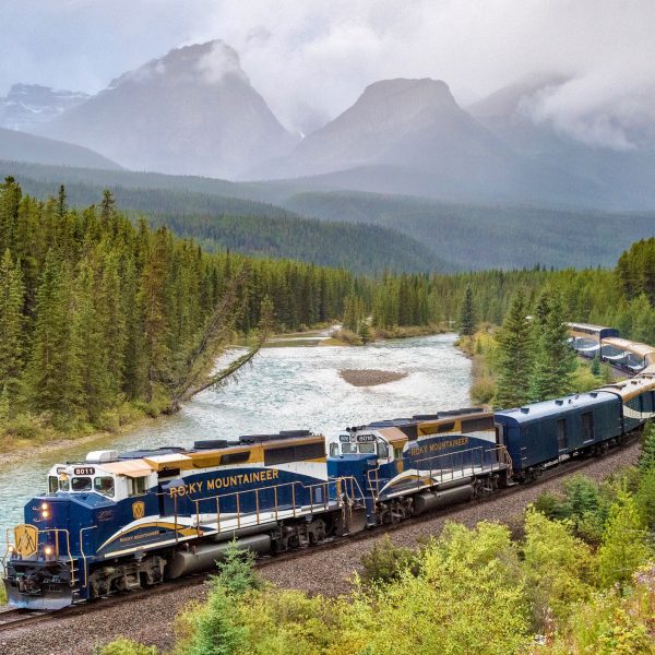 A scenic train journey winding through the majestic Canadian Rockies.