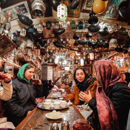 Women around a table in Iran - Intrepid - Women over 50 Tours Iran