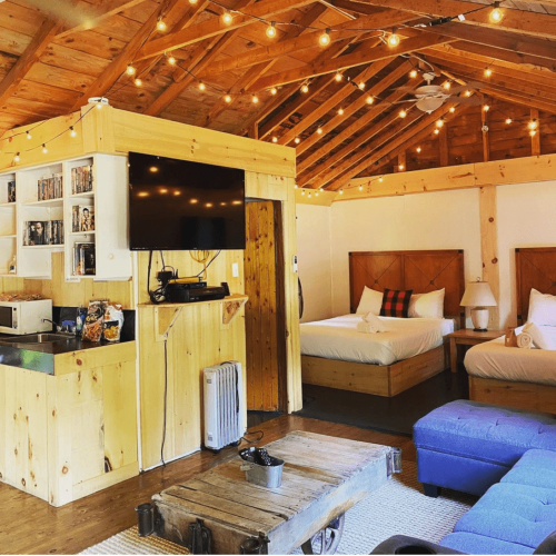 Interior of a bunkie/cabin with double beds at the Muskoka Beer Spa in Torrence, Ontario, recommended by JourneyWoman as a safe place for women to stay.