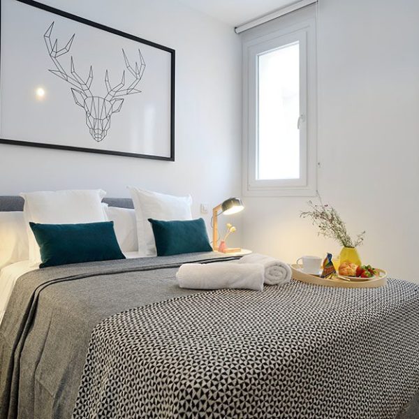 A beautifully decorated and simple room showcases the apartment rental offerings of nQn aparts and suites in Madrid and Seville, Spain