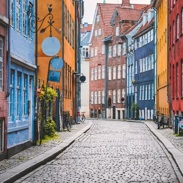 Vibrant row of colorful facades lining the charming streets of Copenhagen showcasing the city's lively and picturesque urban landscape - NORTHERN CAPITALS, A WOMEN-ONLY TOUR - Insight Tours
