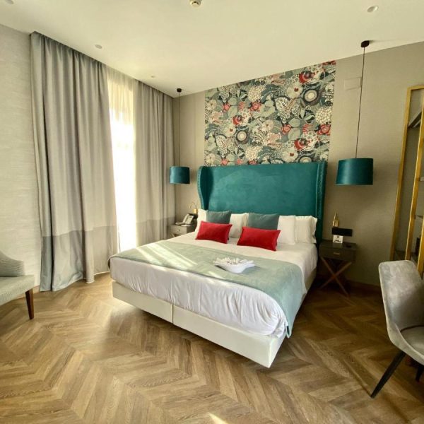 A nicely decorated room with a queen bed and modern art - Soho Boutique Sevilla in Spain, recommended by a JourneyWoman reader as a safe place to stay for women.