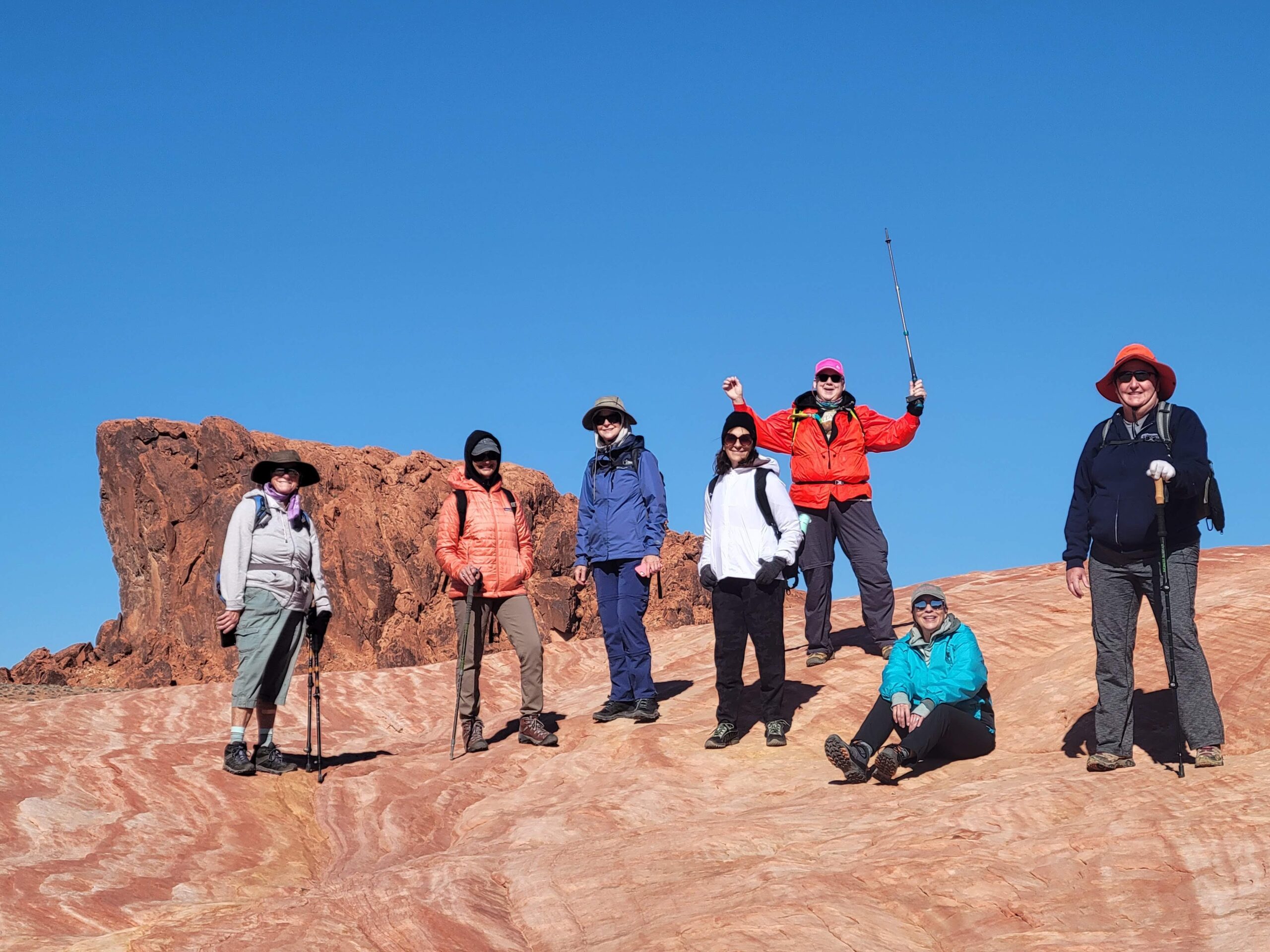 Group of hikers standing on a trail, admiring the canyon - Valley of Fire, Red Rock & Death Valley NP, Canyon Calling