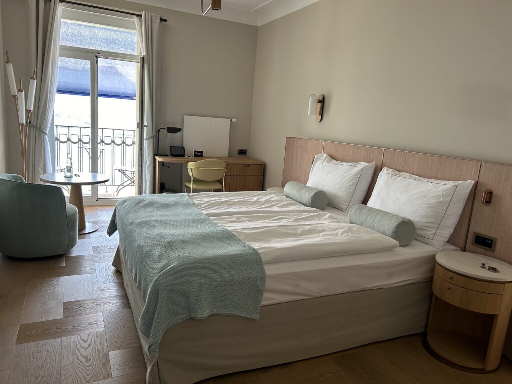 A simple double bed suite with balcony and mountain view at the Art Deco Hotel Montana in Lucerne, Switzerland, recommended as a safe place for women to stay.