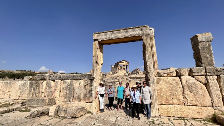 Group of women exploring the ancient Roman ruins of Dougga stop of the tour The Wonders of Tunisia