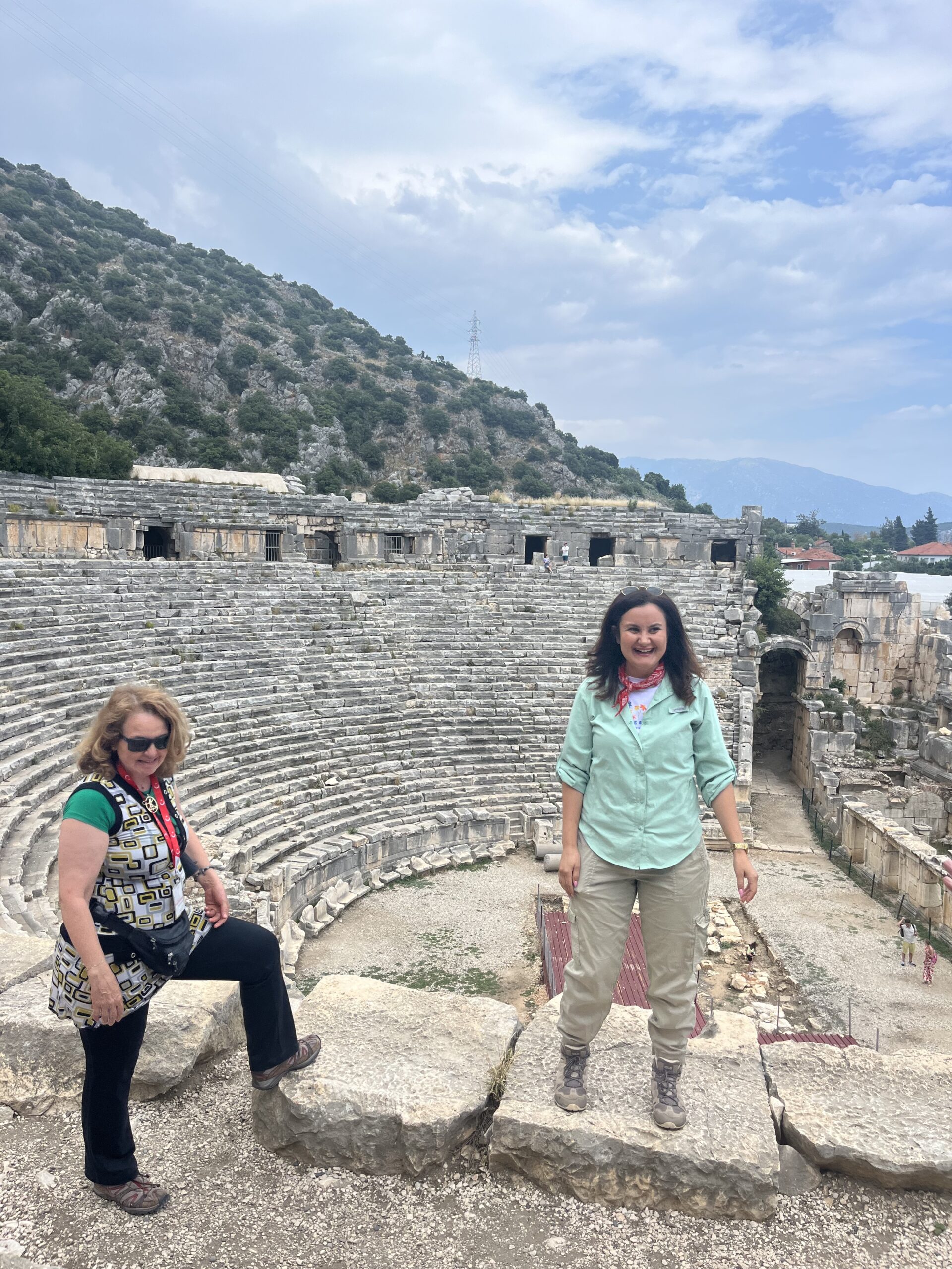 Women exploring the ancient Myra theater, a historic stop on the Western Türkiye Tour, surrounded by impressive stone ruins - Far Horizons