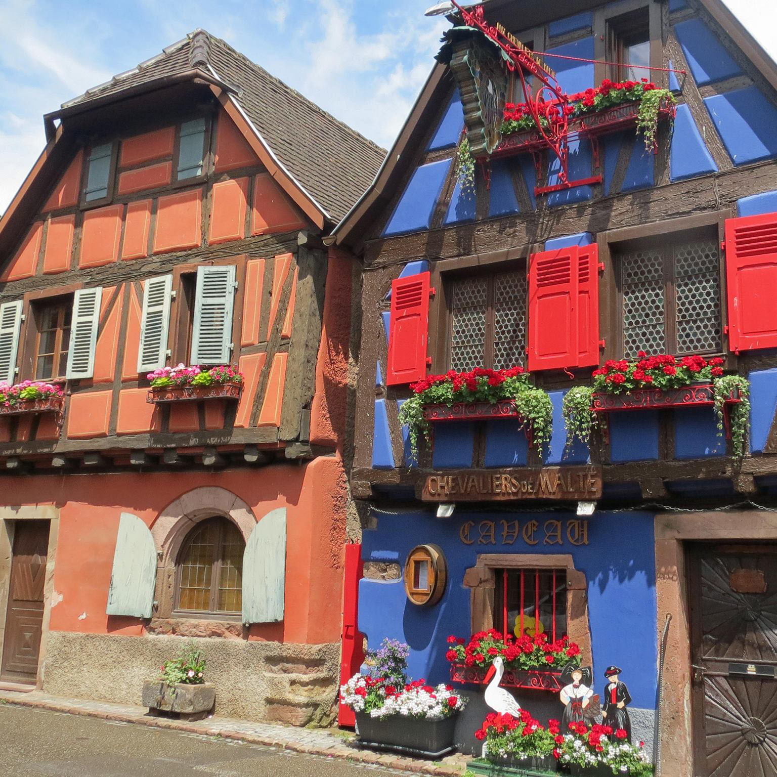 Historic half-timbered house in Niedermorschwihr, featuring vibrant colors and traditional Alsatian architectural details - The Alsace Experience