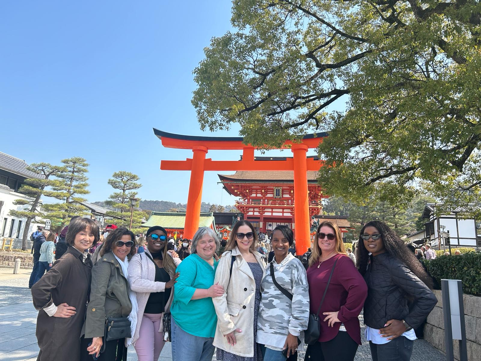 A joyful group of women exploring Japan, surrounded by vibrant cultural landmarks - Cherry Blossoms & Cultural Treasures