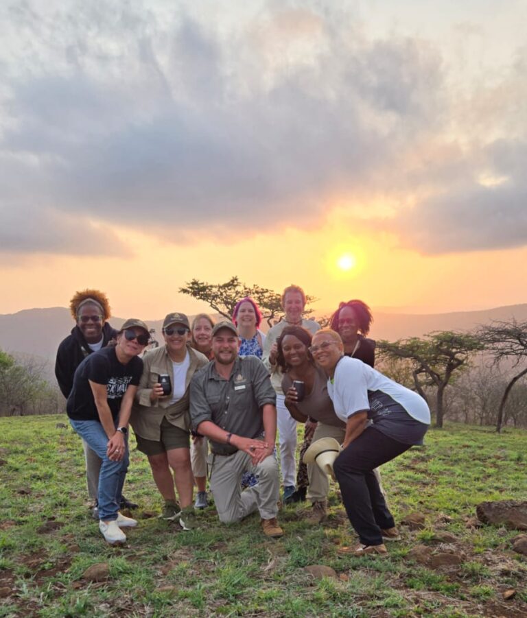 Tour participant capturing a memorable moment during a stunning sunset - South African Splendors