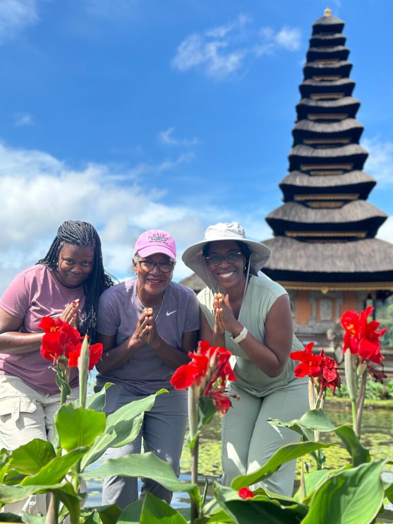 Tour participant posing for a photo outside a traditional Balinese temple - Bliss in Bali