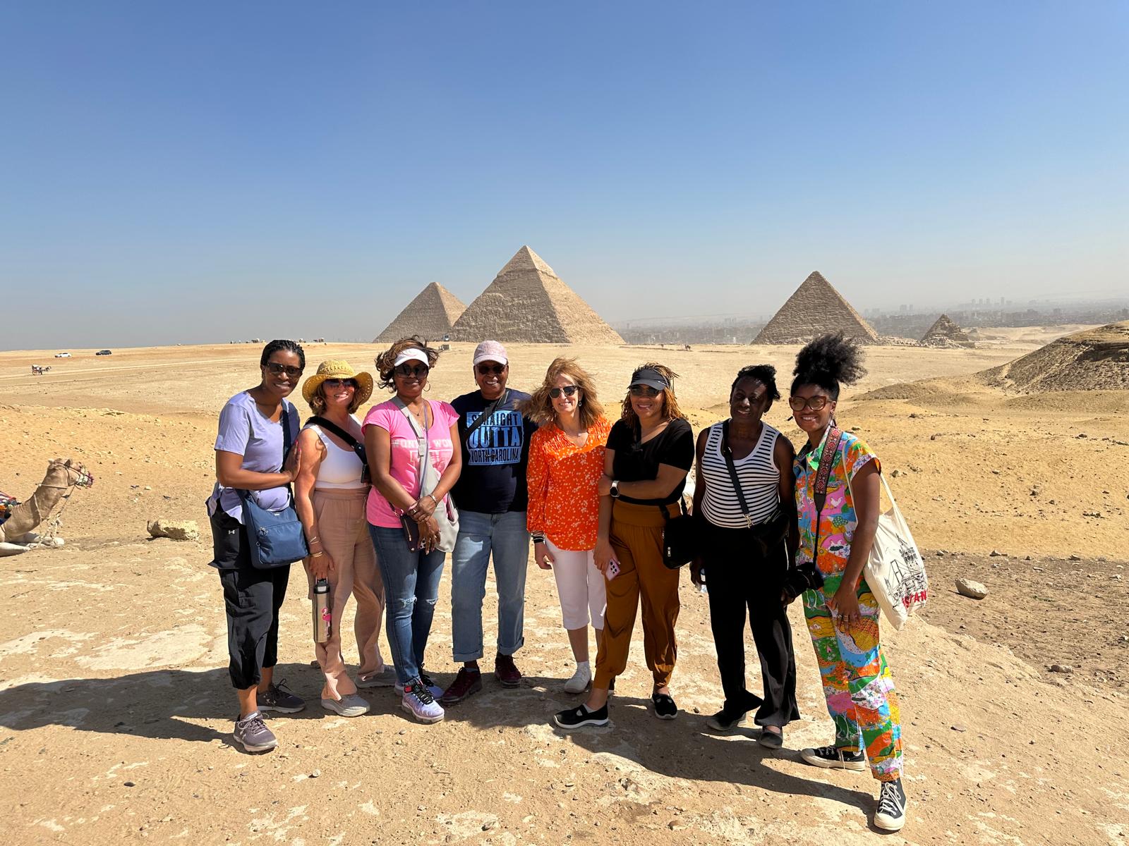 Tour participant posing for a photo with the iconic Giza Pyramid in the background - Ancient Wonders of Egypt