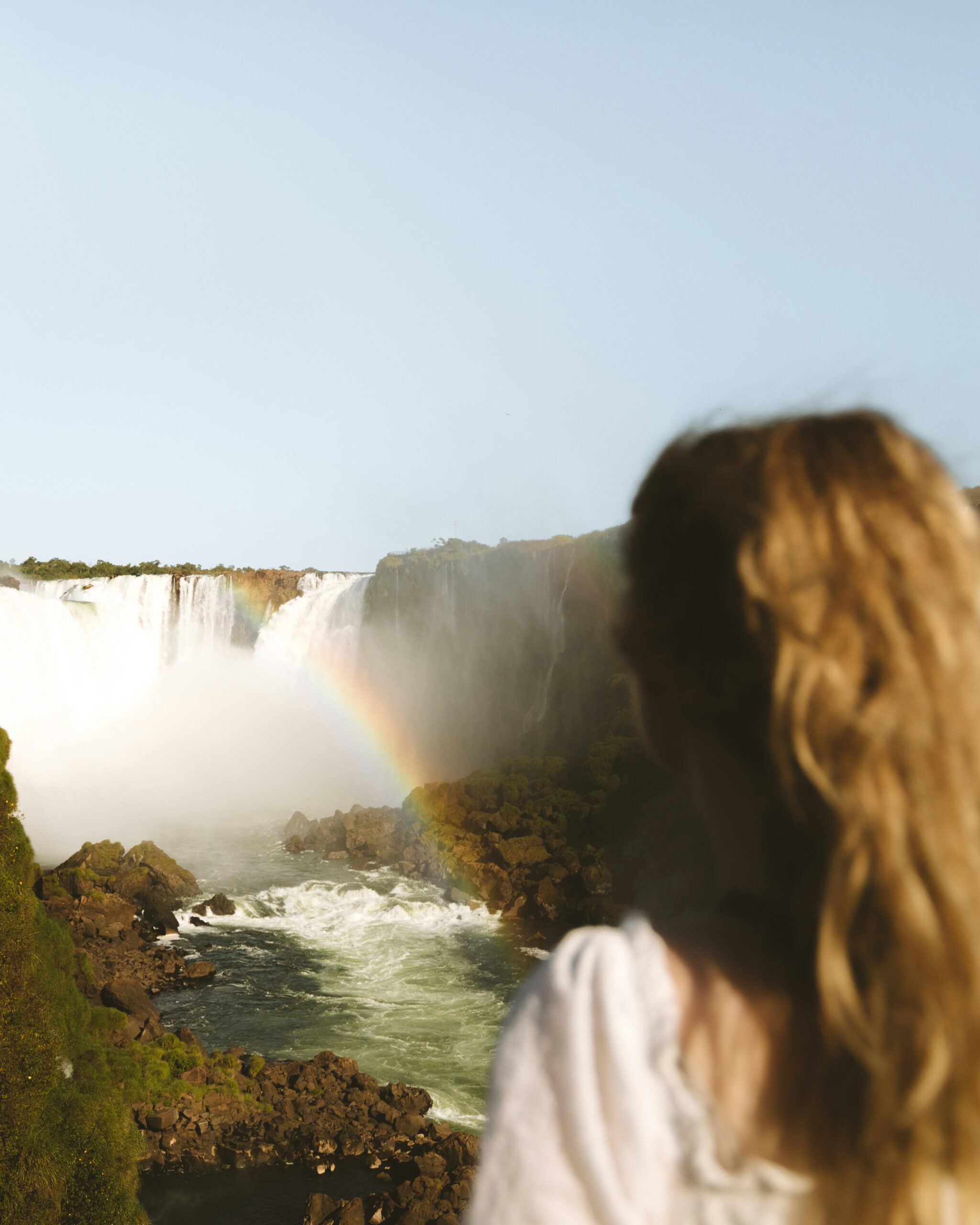 A woman admiring the breathtaking Iguazú Falls - Argentina: Tango, Waterfalls & Flavors