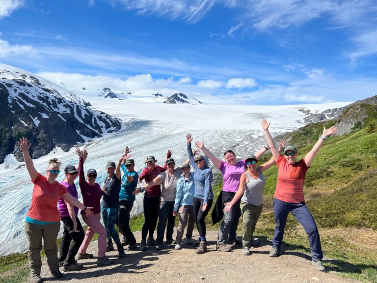 Group of women joyfully celebrating at the summit after completing a scenic hike - Alaska Women’s Adventure Hiking & Multi-Sport Tour