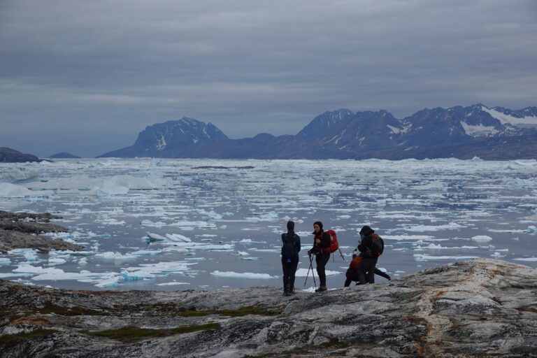 Woman trekking across a stunning glacier - East Greenland Adventure Wild Arctic Trails & Tales