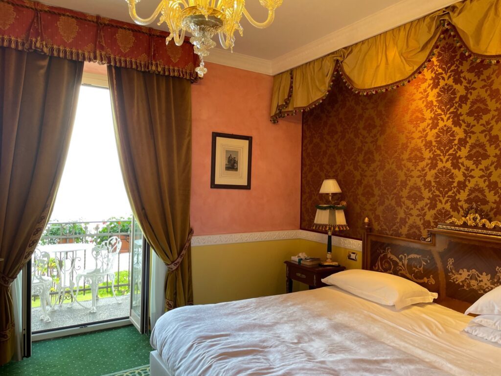 A queen=sized bedroom at the Grand Hotel des Iles Borromées in Stresa, Italy, recommended by a JourneyWoman reader as a safe place for women to stay.
