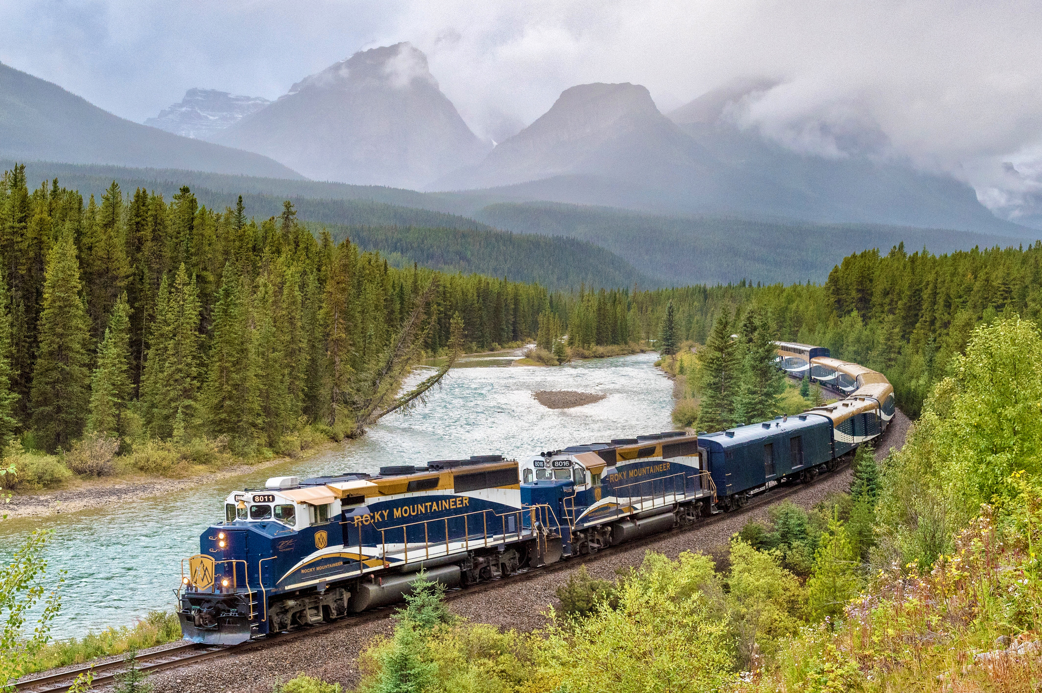 A scenic train journey winding through the majestic Canadian Rockies.