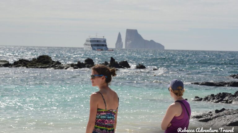 Two women gaze out at the breathtaking Galapagos beach, immersed in its natural beauty and tranquility - 8-Day Galapagos Women's Tour - Rebecca Adventure Travel