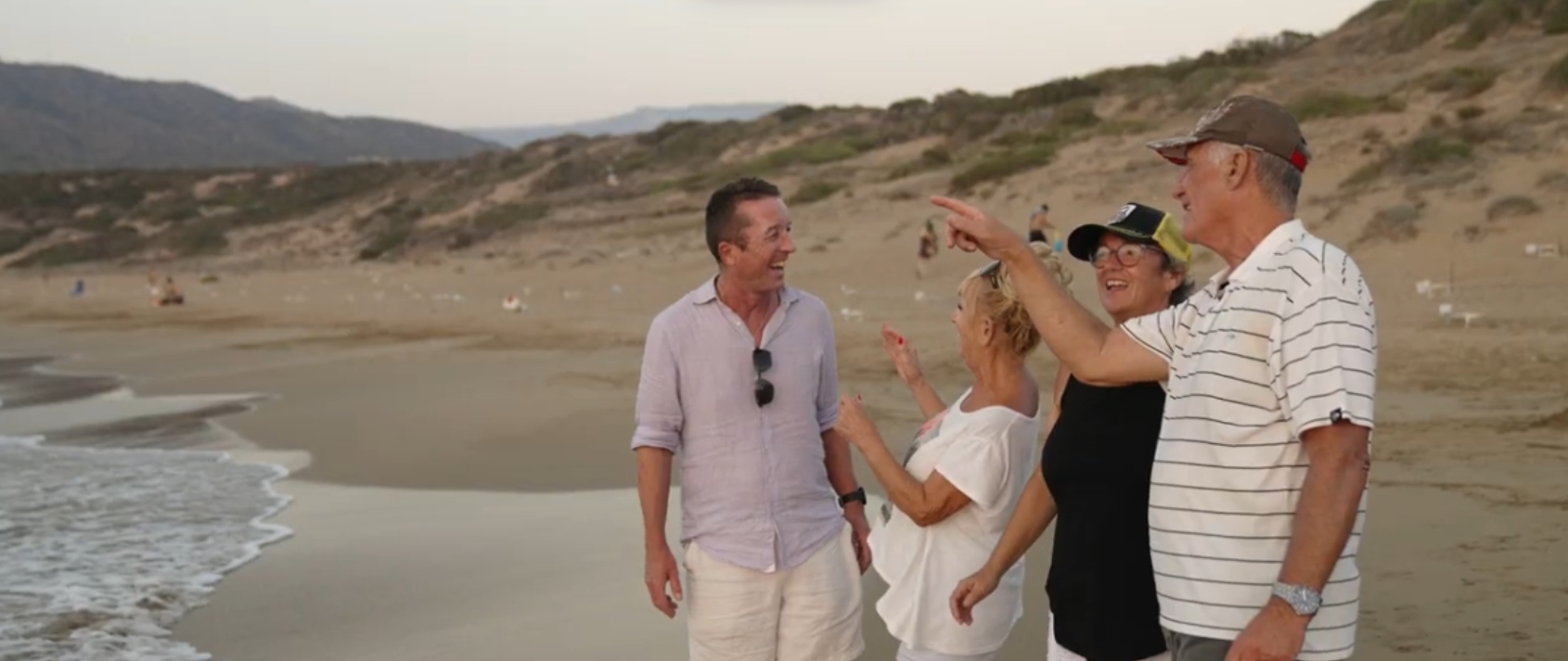 A group of people is enjoying a moment at the serene Akmas beach.